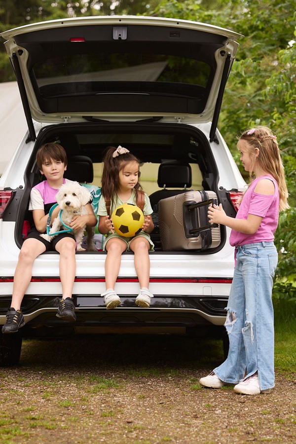 kinderen in achterbak klaar om op vakantie te gaan